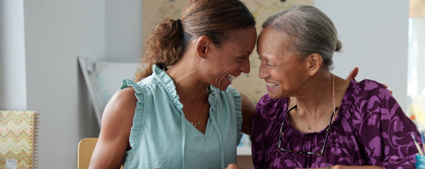 Paulette and her daughter, Danielle, smiling at each other