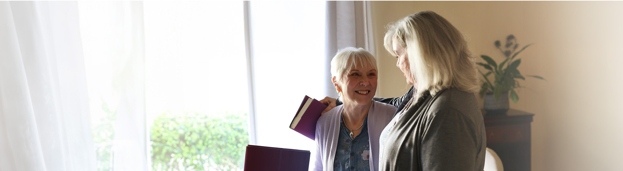 Nina and her friend, smiling at each other