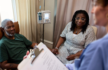Bob, a patient living with early Alzheimer's, and his wife, Cynthia, at an infusion center