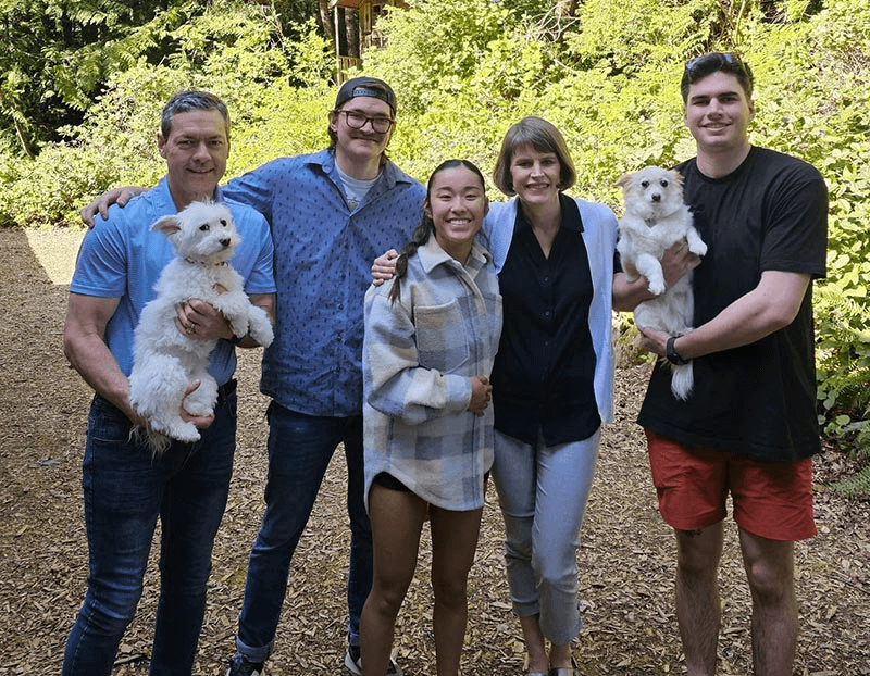 Brian, smiling with his family