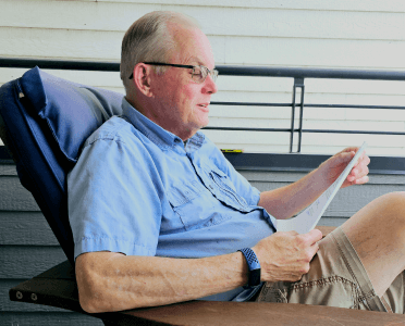 Lance sitting down, reading