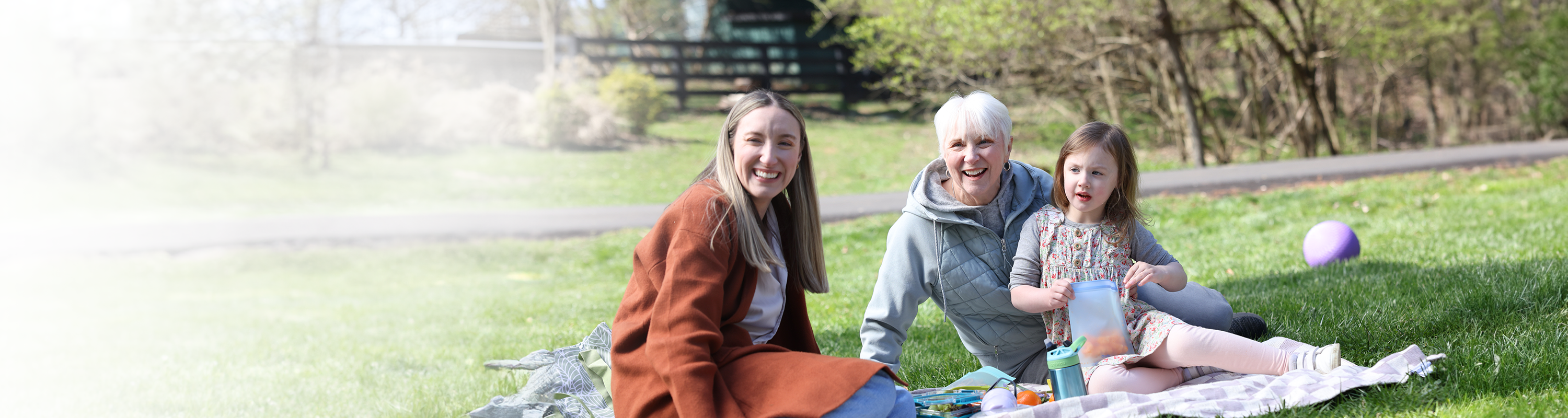 Nina, her daughter, and her granddaughter smiling 