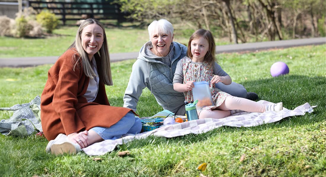 Nina, her daughter, and her granddaughter smiling 